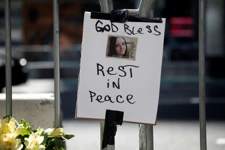 Flowers and a photograph of Alyssa Elsman, the 18 year old woman who was killed when a speeding vehicle struck pedestrians on the sidewalk Thursday is seen at a makeshift memorial at the scene of the incident outside the 3 Times Square building in Times Square in New York City, U.S., May 19, 2017. REUTERS/Mike Segar