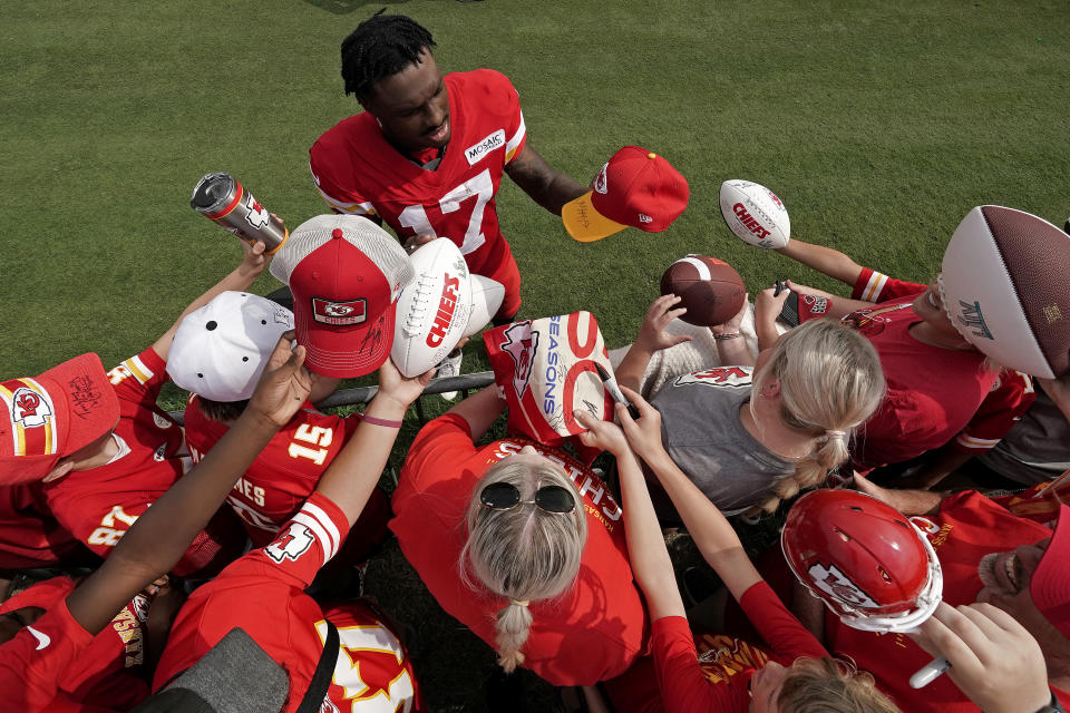 Kansas City Chiefs wide receiver Mecole Hardman signs autographs during NFL football training camp Monday, Aug. 15, 2022, in St. Joseph, Mo. (AP Photo/Charlie Riedel)