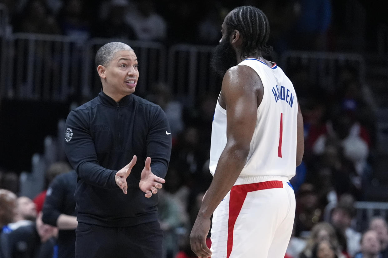 LA Clippers head coach Tyronn Lue talks with guard James Harden (1) during the first half of an NBA basketball game against the Atlanta Hawks Monday, Feb. 5, 2024, in Atlanta. (AP Photo/John Bazemore)
