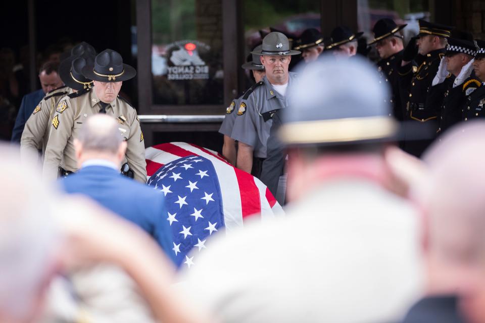 Law enforcement officers carry the casket of Floyd County Deputy William Petry to the hearse after the funeral service at the Mountain Arts Center in Prestonsburg, Ky., Tuesday, July 5, 2022.  Petry and two Prestonsburg city police officers were killed while serving a warrant at a home in the county.  (Silas Walker/Lexington Herald-Leader via AP)