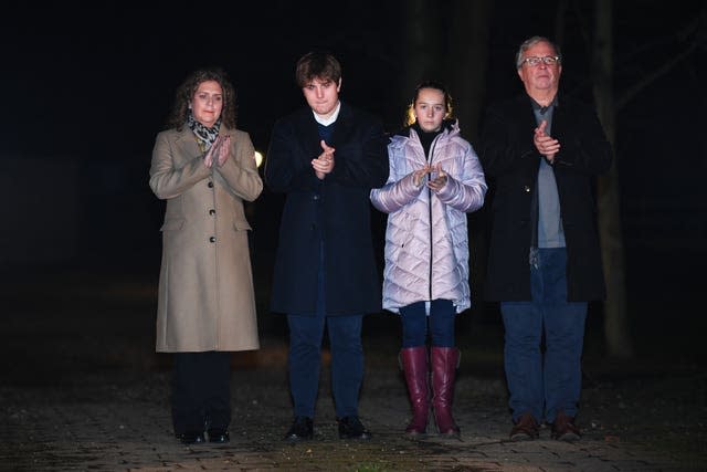 Captain Sir Tom Moore’s daughter Hannah Ingram-Moore, grandson Benji, granddaughter Georgia and son-in-law Colin Ingram outside his home in Marston Moretaine, Bedfordshire, joining in with a nationwide clap in honour of the 100-year-old charity fundraiser who died on Tuesday after testing positive for Covid-19