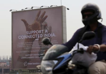 A motorist rides past a billboard displaying Facebook's Free Basics initiative in Mumbai, December 30, 2015. REUTERS/Danish Siddiqui/Files