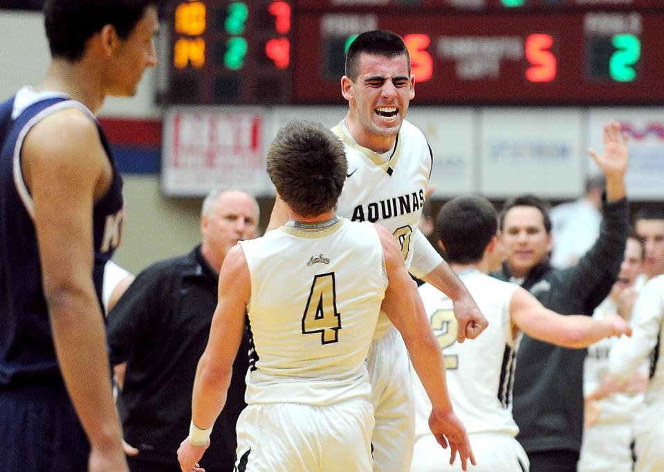 St Thomas Aquinas guards Anthony Moeglin and Jacob Paul celebrate during a 2014 regional game at Memorial Field House.