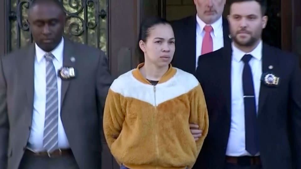 Grei Mendez, center, is escorted  by law enforcement from a New York police station on September 19.
 - WABC-TV/AP/FILE