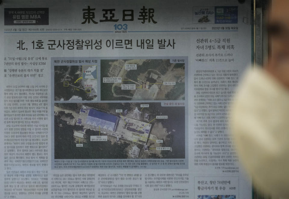 A local newspaper showing file images of the Sohae Satellite Launching Station in Tongchang-ri, North Korea, is displayed in Seoul, South Korea, Tuesday, May 30, 2023. North Korea said Tuesday it would launch its first military spy satellite in June and described space-based reconnaissance as crucial for monitoring the United States' "reckless" military exercises with South Korea. The headline reads "North Korea launches its first military spy satellite tomorrow at the earliest." (AP Photo/Ahn Young-joon)