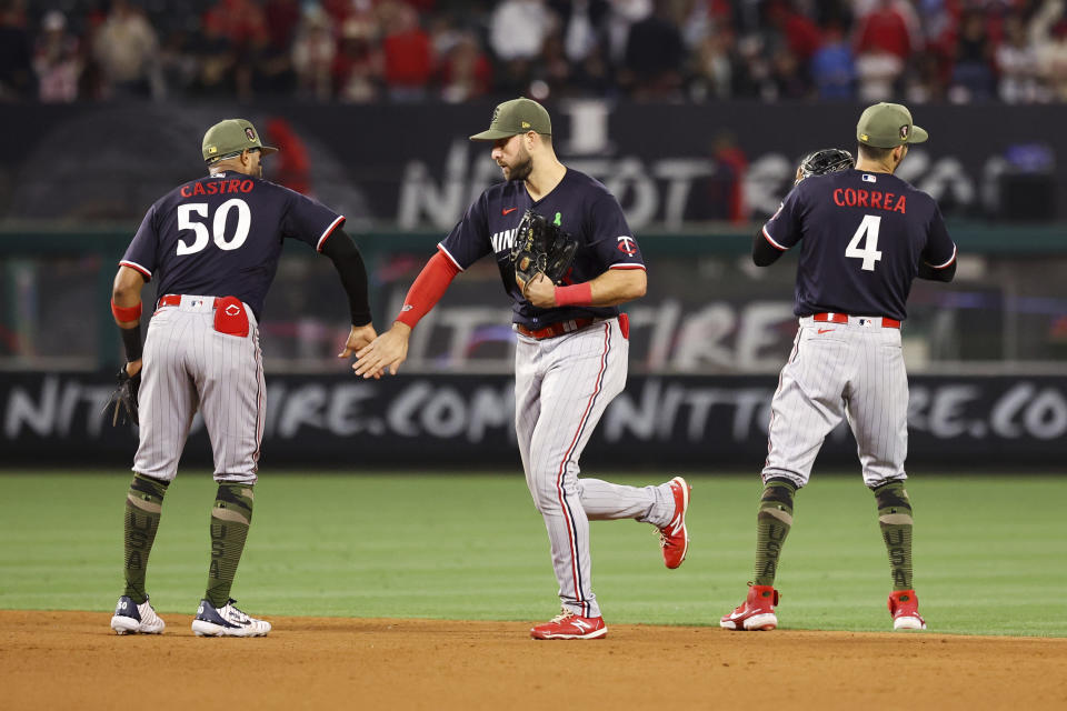 Minnesota Twins left fielder Joey Gallo and second baseman Willi Castro (50) celebrate as shortstop Carlos Correa (4) looks on after defeating the Los Angeles Angels 6-2 during a baseball game in Anaheim, Calif., Saturday, May 20, 2023. (AP Photo/Jessie Alcheh)