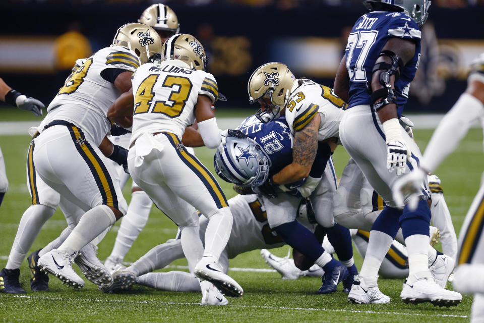 Dallas Cowboys running back Ezekiel Elliott (21) carries as New Orleans Saints outside linebacker A.J. Klein (53) tackles in the first half of an NFL football game in New Orleans, Sunday, Sept. 29, 2019. (AP Photo/Butch Dill)