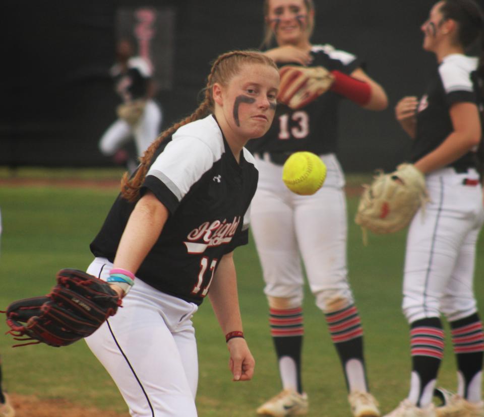 Creekside pitcher Kaylee Martineau (17) follows through after a backhand flip from her glove to first base during pregame infielder warm-ups.