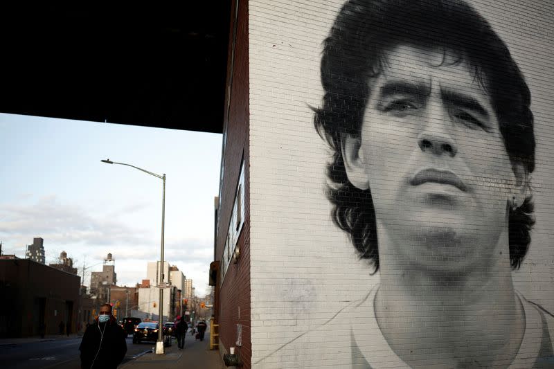 A man walks past a mural depicting late Argentine football legend Diego Maradona in New York City