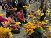 <p>Relatives of victims burn incense and paper money to mourn their dead relatives at the site of a landslide in the village of Xinmo, Mao County, Sichuan Province, China, June 26, 2017. (Photo: Aly Song/Reuters) </p>