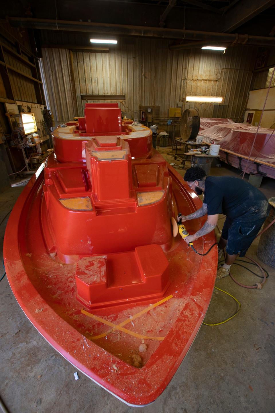 A worker buffs a fiberglass plug under production at Marine Concepts on Pine Island Road in Cape Coral.