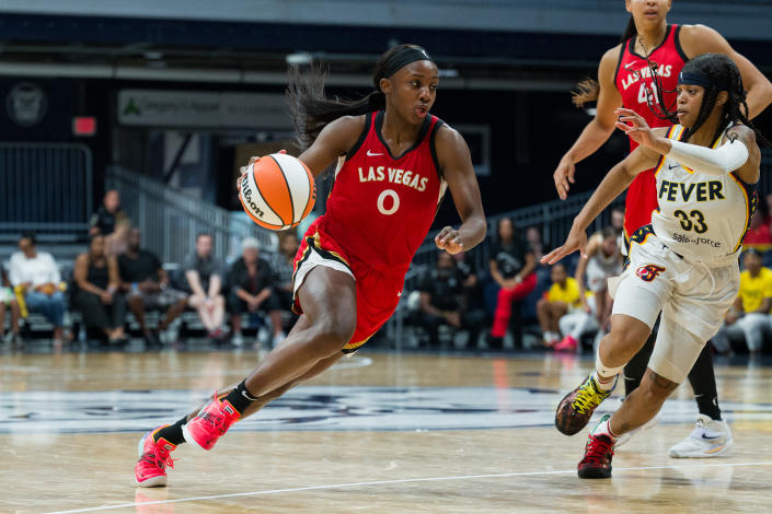 Las Vegas Aces guard Jackie Young (0) drives past Indiana Fever guard Destanni Henderson (33) during the Indiana Fever vs Las Vegas Aces WNBA game on July 31, 2022 at Hinkle Fieldhouse in Indianapolis, IN. (Photo by Zach Bolinger/Icon Sportswire via Getty Images)