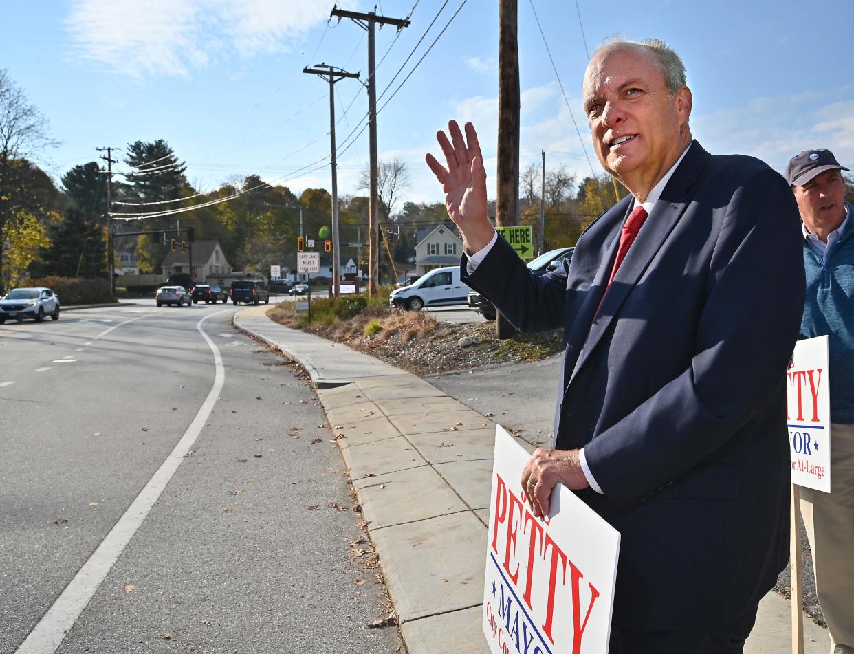 Incumbent mayor Joe Petty waves to motorists in front of the Unitarian Universalist Church at Shore Drive and Holden Street Tuesday afternoon.