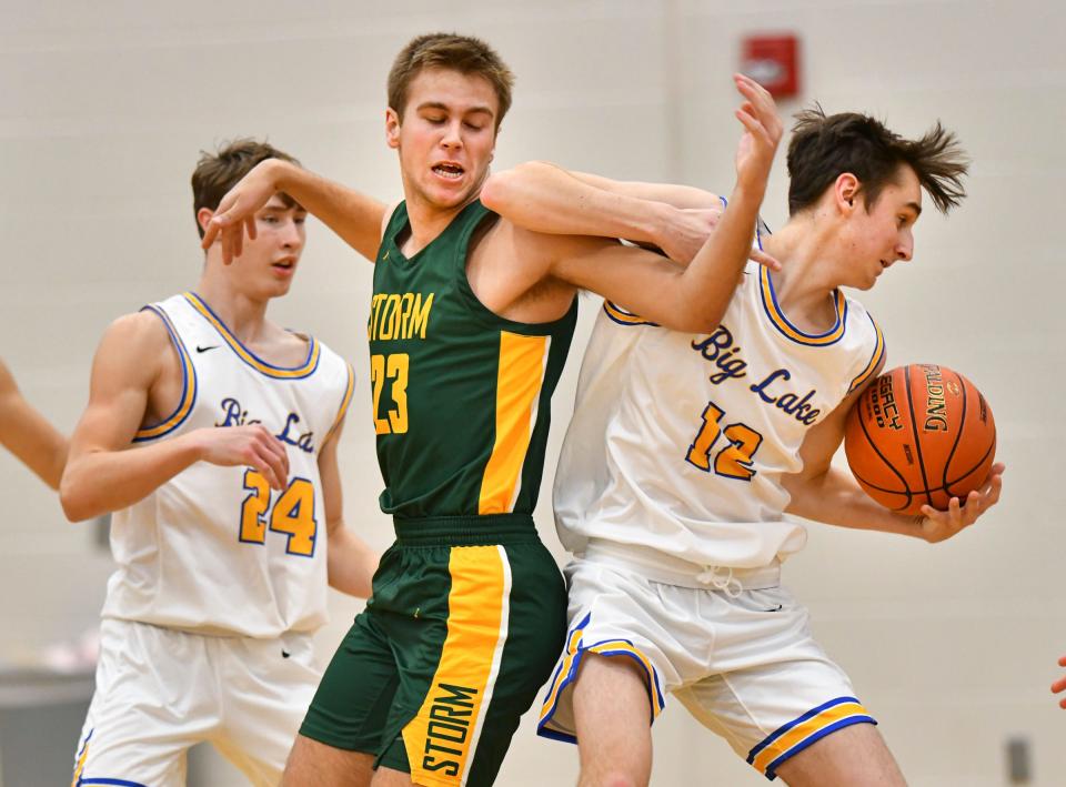 Alexander Harren of Sauk Rapids gets tangled with Big Lake's Riley Siegriest during the first half of the game Tuesday, Dec. 7, 2021, at Sauk Rapids-Rice High School.