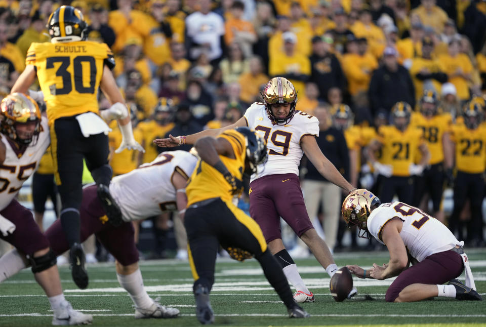 Minnesota place kicker Dragan Kesich (99) kicks a field goal during the second half of an NCAA college football game against Iowa, Saturday, Oct. 21, 2023, in Iowa City, Iowa. (AP Photo/Matthew Putney)