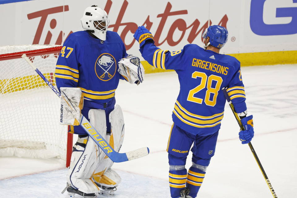 Buffalo Sabres goalie Malcolm Subban (47) and Buffalo Sabres left wing Zemgus Girgensons (28) celebrate a 2-1 victory following the third period of an NHL preseason hockey game against the Philadelphia Flyers, Tuesday, Sept. 27, 2022, in Buffalo, N.Y. (AP Photo/Jeffrey T. Barnes)