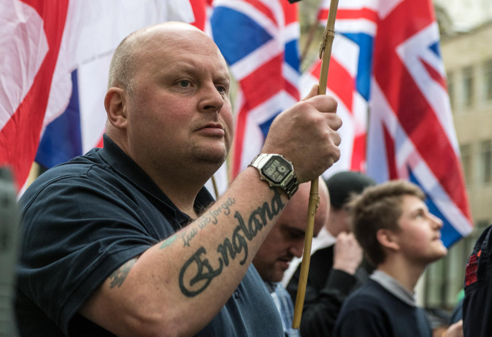 LONDON, ENGLAND - APRIL 01: A protester waves a British Union Jack with a 'England' tatoo on his arm during a protest titled 'London march against terrorism' in response to the March 22 Westminster terror attack on April 1, 2017 in London, England. The march has been organised by far-right groups English Defence League and Britain First, which also sees a counter-protest held by group 'Unite Against Fascism'. During the terror attack in Westminster, Khalid Masood killed 4 people as he drove a car into pedestrians over Westminster Bridge and stabbed PC Keith Palmer to death before being shot dead himself. (Photo by Chris J Ratcliffe/Getty Images)