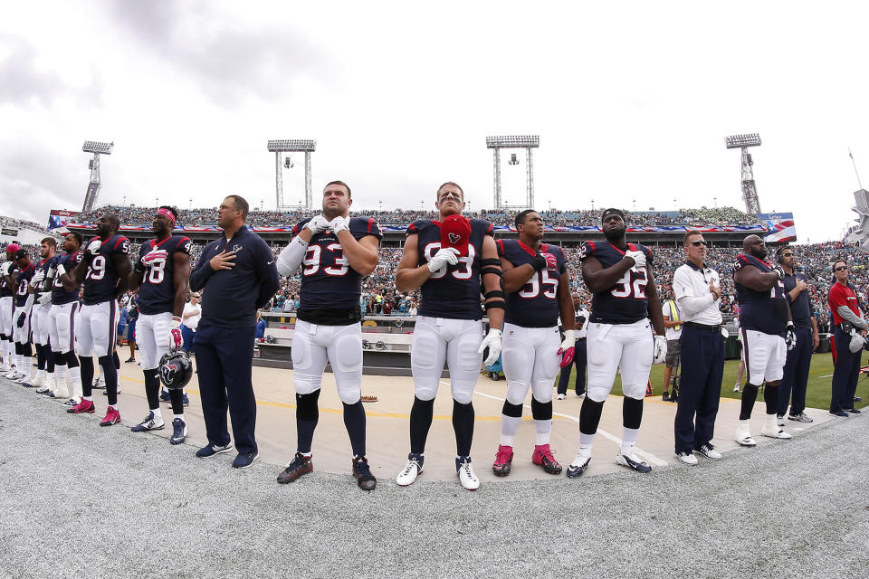 JACKSONVILLE, FL - OCTOBER 18: A general view of Defensive End J.J. Watt #99 and his teammates of the Houston Texans during the national anthem before playing the Jacksonville Jaguars at EverBank Field on October 18, 2015 in Jacksonville, Florida. The Texans defeated the Jaguars 31 to 20. (Photo by Don Juan Moore/Getty Images)