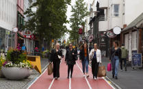 A group of women walk down Laugavegur, the main shopping street in Reykjavik, Iceland Saturday Aug. 1, 2020. In Iceland, a nation so safe that its president runs errands on a bicycle, U.S. Ambassador Jeffery Ross Gunter has left locals aghast with his request to hire armed bodyguards. He's also enraged lawmakers by casually and groundlessly hitching Iceland to President Donald Trump's controversial "China virus” label for the coronavirus. (AP Photo/Árni Torfason)