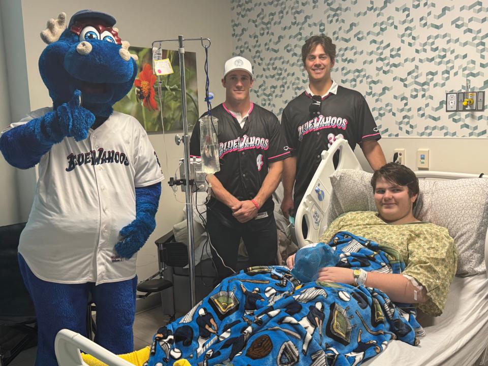 Pensacola Blue Wahoos players Jacob Berry and Ike Buxton, along with team mascot Kazoo, take a picture with Milton's Jackson Jordan at the HCA Florida West Hospital on Thursday, Jan. 18, 2024.