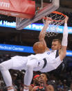 Dallas Mavericks center Kristaps Porzingis dunks in front of Toronto Raptors forward Scottie Barnes during the first quarter of an NBA basketball game in Dallas, Wednesday, Jan. 19, 2022. (AP Photo/LM Otero)