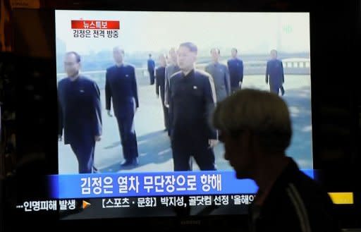 A South Korean watches a TV newscast reporting the visit to China by North Korea's Kim Jong-un, the son of leader Kim Jong-Il, at a railway station in Seoul on May 20