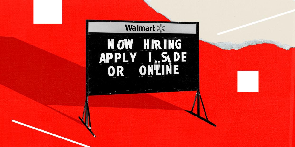 A sign outside a Walmart says, "Now hiring. Apply inside or online."