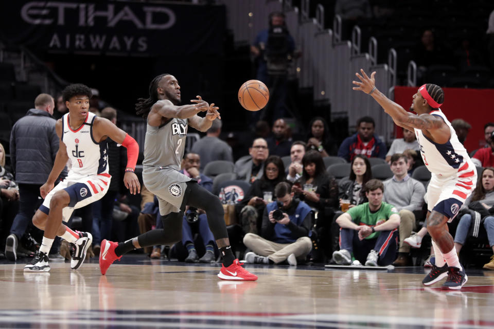 Brooklyn Nets' Taurean Prince, center, passes the ball as Washington Wizards' Rui Hachimura (8) and Bradley Beal, right, defend during the first half of an NBA basketball game Wednesday, Feb. 26, 2020, in Washington. (AP Photo/Luis M. Alvarez)