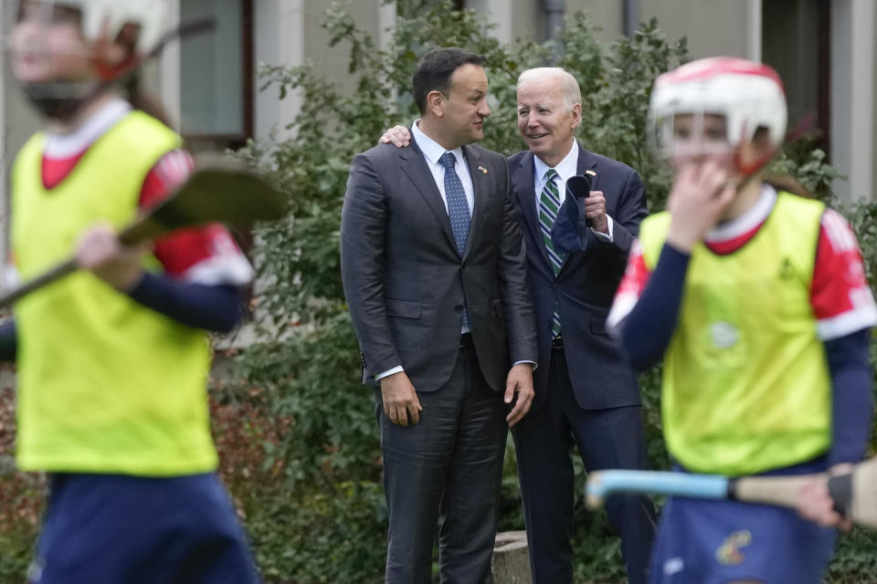 President Joe Biden and Ireland's Taoiseach Leo Varadkar watch as girls play hurling during a youth Gaelic sports demonstration at Farmleigh House, Thursday, April 13, 2023, in Dublin, Ireland. (AP Photo/Patrick Semansky)