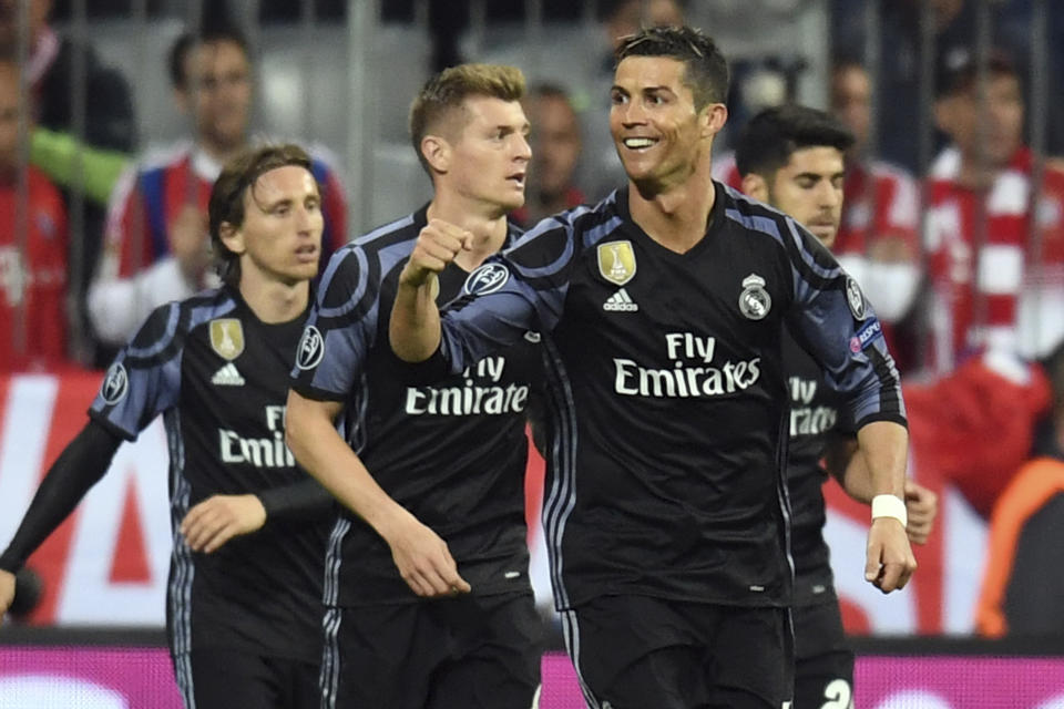 Real Madrid's Cristiano Ronaldo, front, celebrates after scoring his side's 2nd goal during the Champions League quarterfinal first leg soccer match between FC Bayern Munich and Real Madrid, in Munich, Germany, Wednesday, April 12, 2017. (Sven Hoppe/dpa via AP)