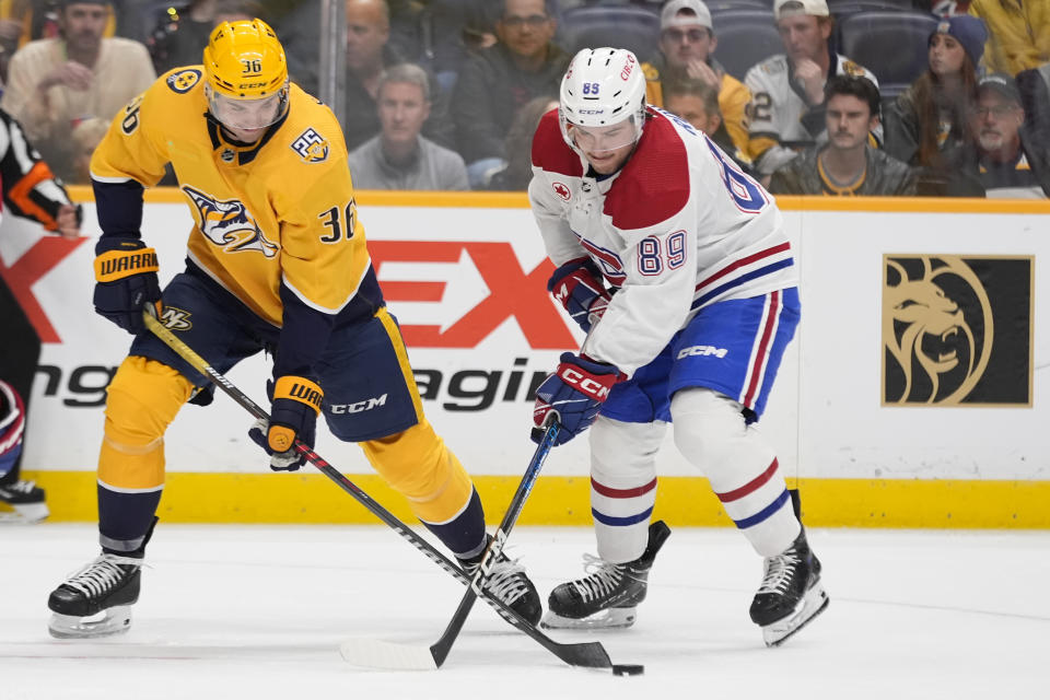 Nashville Predators left wing Cole Smith (36) battles Montreal Canadiens right wing Joshua Roy (89) for the puck during the second period of an NHL hockey game Tuesday, March 5, 2024, in Nashville, Tenn. (AP Photo/George Walker IV)