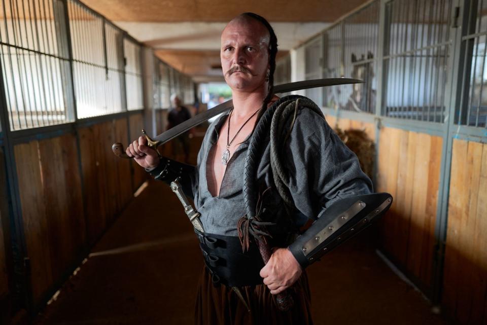 A Ukrainian Cossack, named Paliy, wearing traditional Cossack clothes on Sept. 6, 2023 in Zaporizhzhia, Ukraine. Paliy is a member of a group of eight Ukrainian Cossacks, two of whom died fighting Russian forces on the frontline. The other members are currently enrolled in the Ukrainian forces. (Pierre Crom/Getty Images)