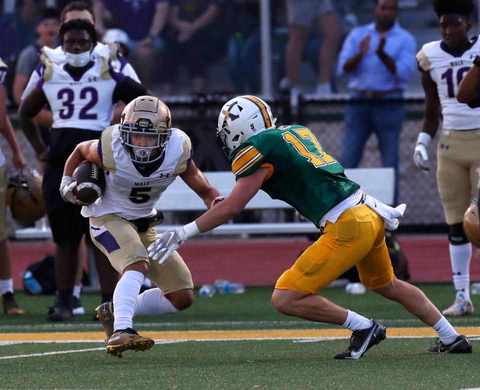 Male’s Max Gainey makes the catch before running into St. X’s William Walters.
Sept. 3, 2021