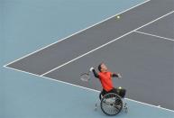 Jamie Burdekin of Britain serves to countryman Peter Norfolk during a wheelchair tennis invitational test event, ahead of the London 2012 Paralympic Games, at Eton Manor in the Olympic Park at Stratford, east London May 4, 2012.