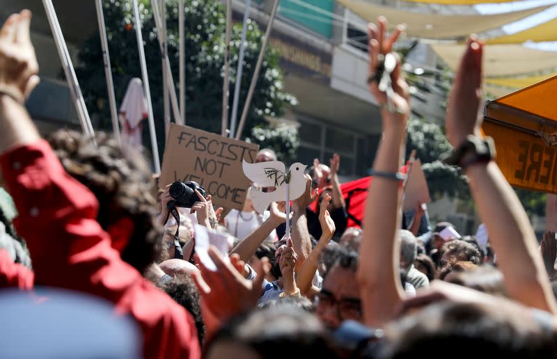 Greek Cypriots shout slogans at the Ledra checkpoint of the U.N.-controlled buffer zone, after authorities declared the crossing temporarily shut to curb any potential spread of coronavirus, in Nicosia