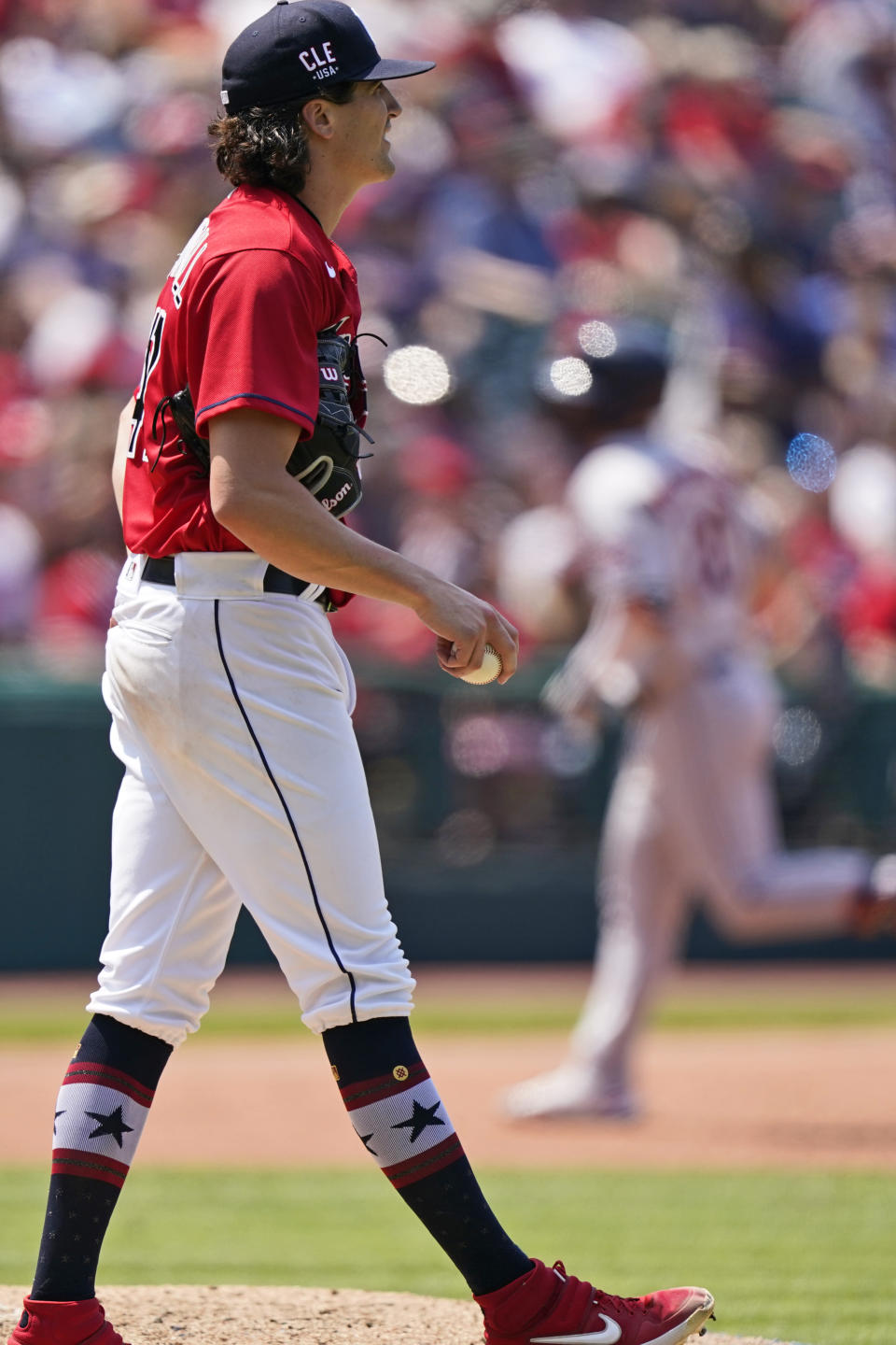 Cleveland Indians starting pitcher Cal Quantrill, left, waits for Houston Astros' Chas McCormick to run the bases after McCormick hit a two run home run in the sixth inning of a baseball game, Sunday, July 4, 2021, in Cleveland. (AP Photo/Tony Dejak)