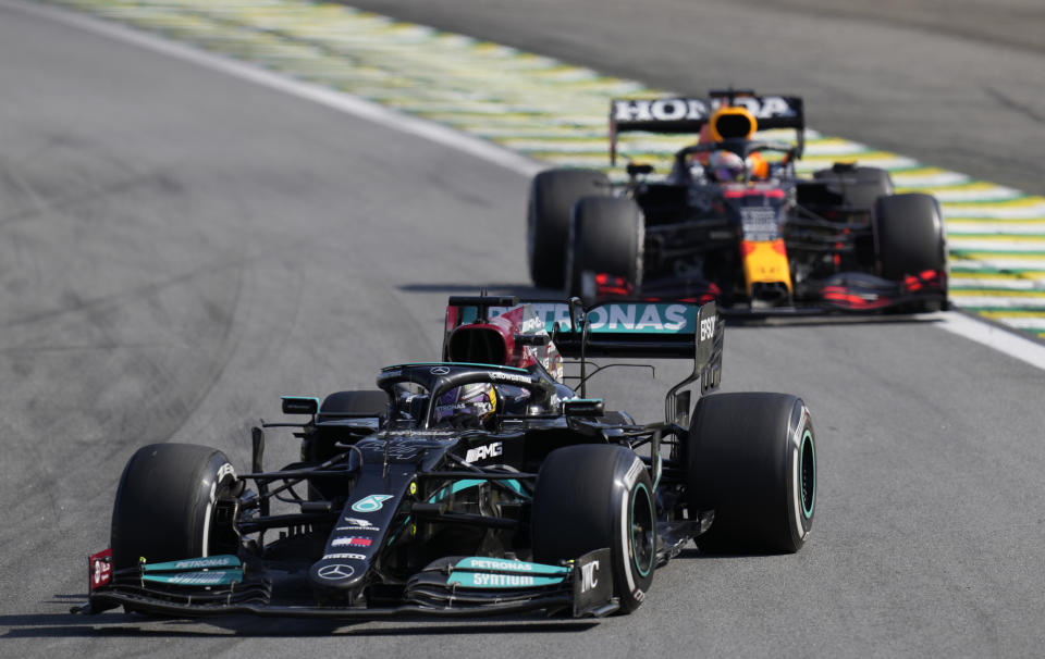 Mercedes' Lewis Hamilton, front, steers his car followed by Red Bull's Max Verstappen , during the Brazilian Formula One Grand Prix at the Interlagos race track in Sao Paulo, Brazil, Sunday, Nov. 14, 2021. (AP Photo/Andre Penner)