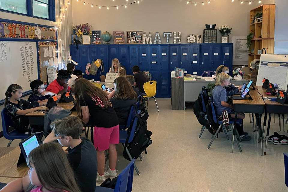 Piedmont Elementary School math teacher Cassie Holbrooks works with a small group of fourth grade students in Piedmont, Ala., on Thursday, Aug. 31, 2023. The rest of her class is working independently. (Trisha Powell Crain/AL.com via AP)