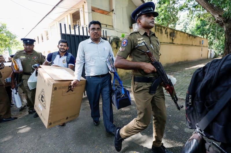 Sri Lankan police and election officials load ballot boxes and papers into busses from a distribution center to polling stations, ahead of country's presidential election scheduled on November 16, in Colombo