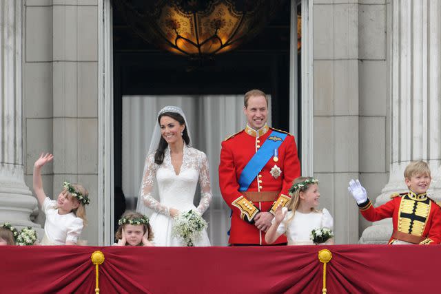 <p>George Pimentel/WireImage</p> Kate Middleton and Prince William with their wedding party on the Buckingham Palace balcony