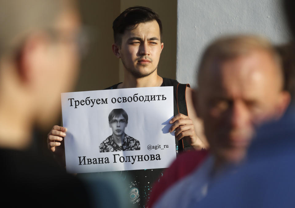 A supporter of Ivan Golunov, a journalist who worked for the independent website Meduza, holds a poster reading "We demand to free Ivan Golunov!", in St.Petersburg, Russia, Saturday, June 8, 2019. A prominent Russian investigative journalist has been charged with drug dealing after four grams of the synthetic stimulant mephedrone were found in his backpack, Moscow police said Friday. (AP Photo/Dmitri Lovetsky)