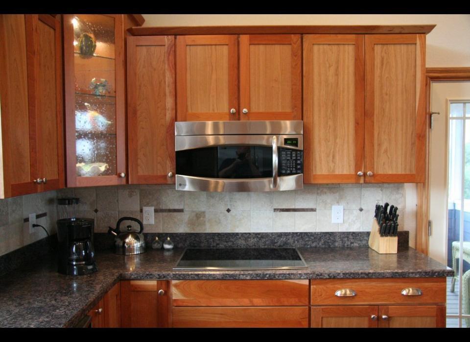 Instead of gutting and rebuilding your kitchen cabinets, why not just reface them? First, remove all the cabinet doors. Then fill any depressions with wood putty and sand it smooth. Next, clean your cabinets with mild soap and water. Pre-cut plywood panels to the size of your cabinets and then apply carpenter's glue to one side. Apply the panels to the pre-existing cabinet with nails. Then, add self-adhesive covering and trim to the cabinets. Finally, sand inside your cabinets and install your doors.     For a full tutorial, watch this video from <a href="http://www.youtube.com/watch?v=6nYcOhbl7JE." target="_hplink">Cabinet Doors Depot. </a>  