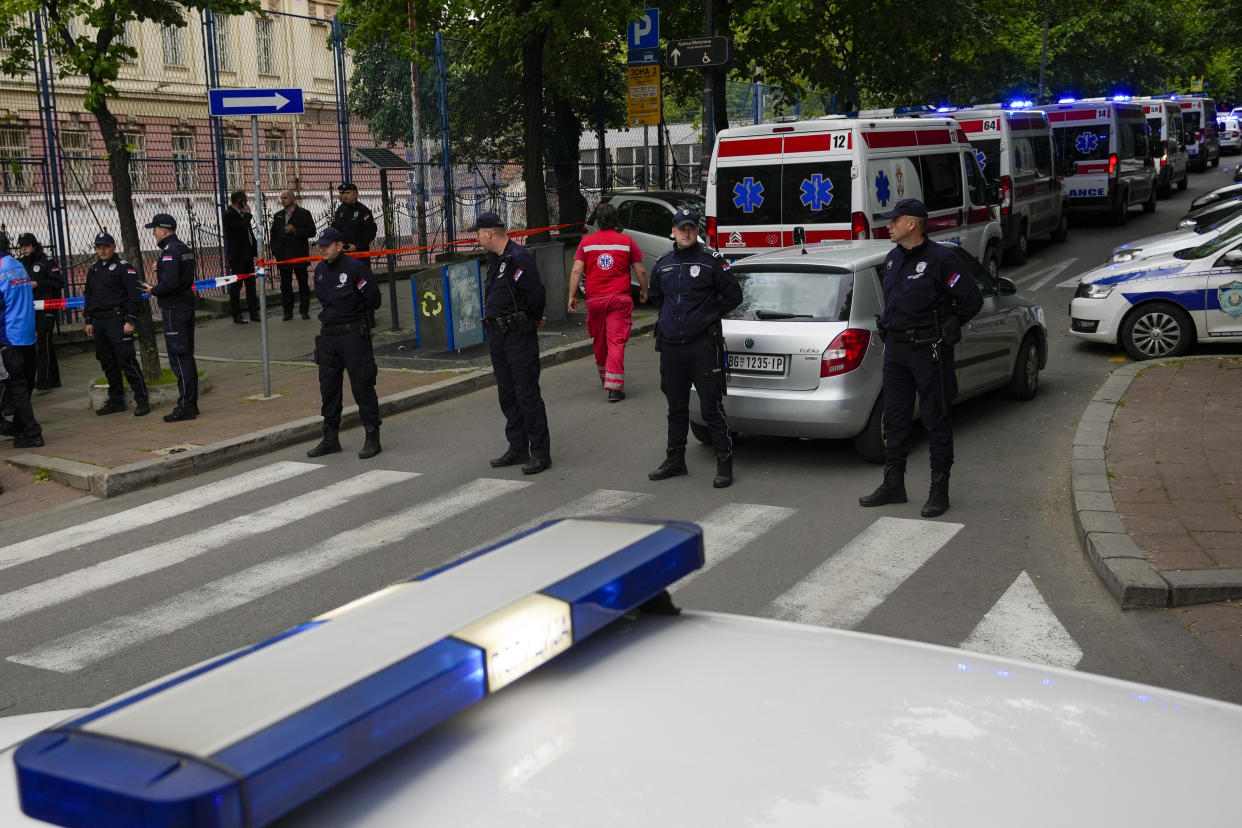 Police officers block the street around the Vladislav Ribnikar school in the very center of Belgrade, Serbia, Wednesday, May 3, 2023. A teenage boy opened fire early Wednesday in a school in central Belgrade, causing injuries, Serbian police said. (AP Photo/Darko Vojinovic)