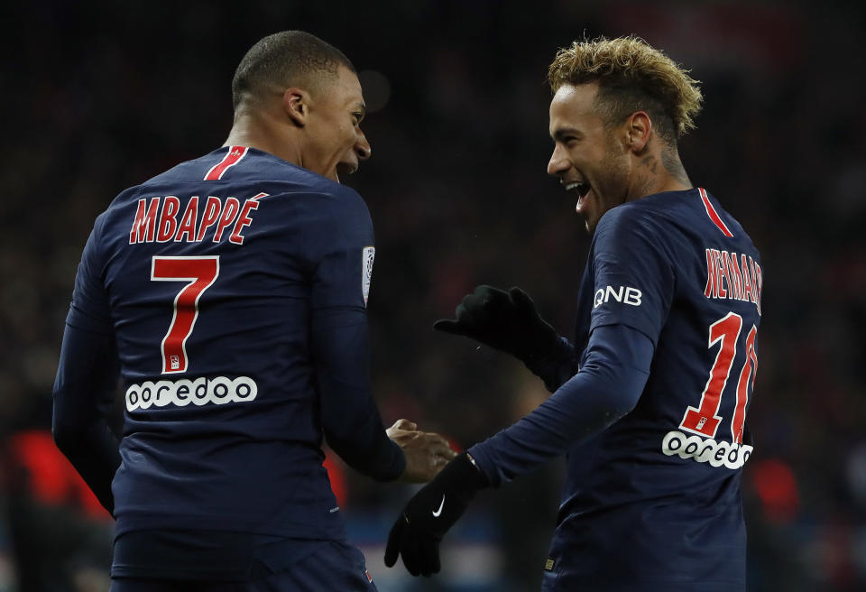 FILE - PSG's Kylian Mbappe, left, reacts with PSG's Neymar, celebrating after he scored his side's second goal during the League One soccer match between Paris Saint-Germain and Lille at the Parc des Princes stadium in Paris, Friday, Nov. 2, 2018. Mbappe has told Paris Saint-Germain he will leave the club at the end of the season, it was reported on Thursday, Feb. 15, 2024. (AP Photo/Thibault Camus, File)