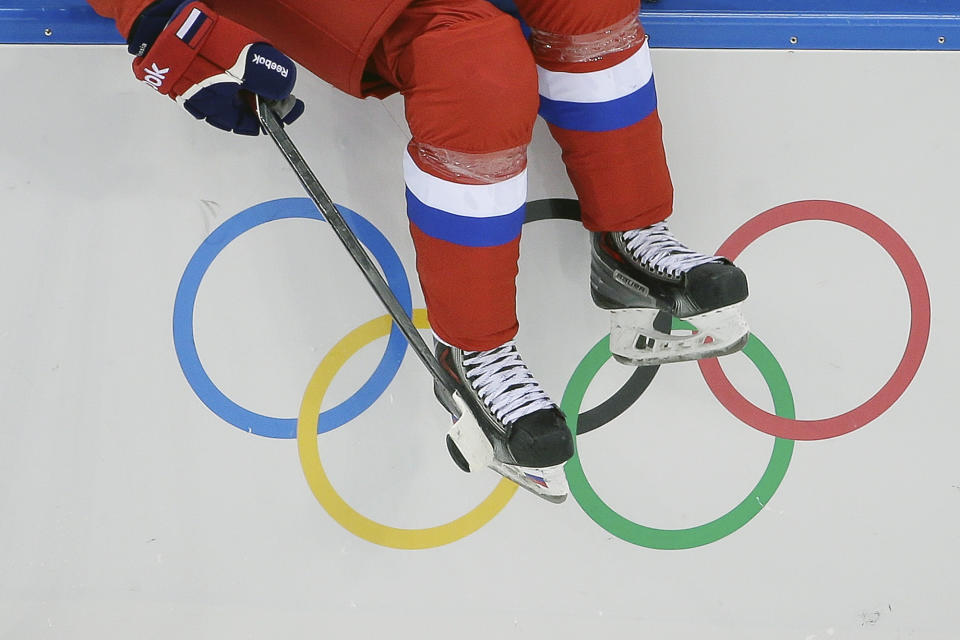 Svetlana Tkachyova of Russia sits on the boards waiting to the enter the game against Germany during the first period of the 2014 Winter Olympics women's ice hockey game at Shayba Arena, Sunday, Feb. 9, 2014, in Sochi, Russia. (AP Photo/Matt Slocum)