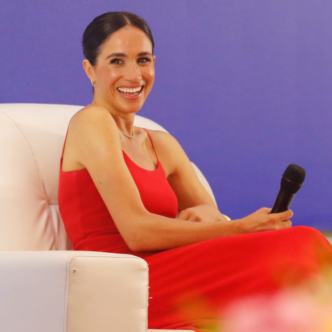  Meghan Markle wears a red dress with thin straps by Orire while onstage at a Women in Leadership panel. 