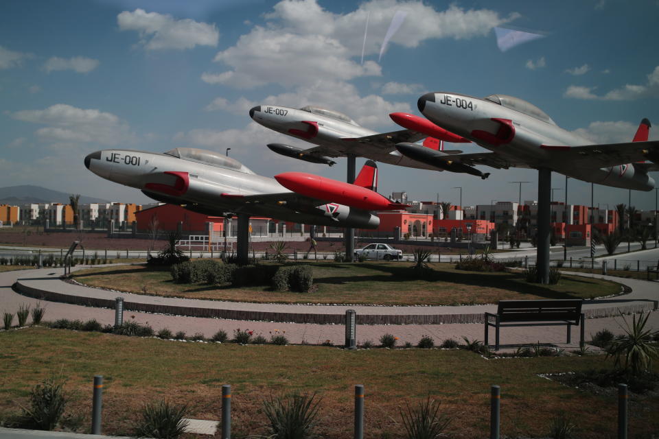 FILE - Vintage Mexican Air Force jets are displayed on a roundabout of the new Felipe Angeles International Airport, on the outskirts of Mexico City, Jan. 31, 2022. The new airport was built by the Army outside Mexico City a year ago at a cost of $4.1 billion. (AP Photo/Ginnette Riquelme, File)