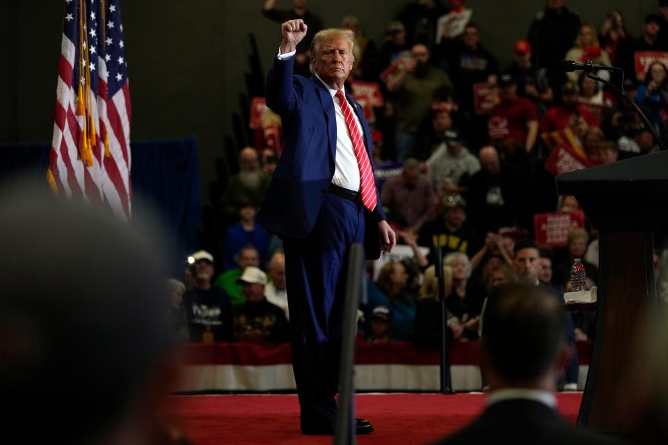 Republican presidential candidate former President Donald Trump stands on stage after speaking during a commit to caucus rally, Saturday, Jan. 6, 2024, in Clinton, Iowa. (AP Photo/Charlie Neibergall)