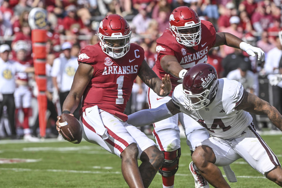 Arkansas quarterback KJ Jefferson (1) is sacked by Mississippi State linebacker Nathaniel Watson (14) during the first half of an NCAA college football game Saturday, Oct. 21, 2023, in Fayetteville, Ark. (AP Photo/Michael Woods)