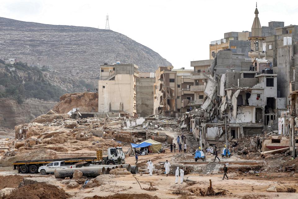 Rescue teams walk in a destroyed area in Libya's eastern city of Derna, Sept. 18, 2023, following deadly flash floods. / Credit: MAHMUD TURKIA/AFP/Getty